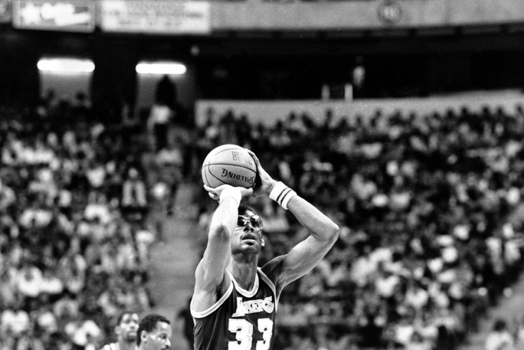 A man holding onto the basketball in his hand.