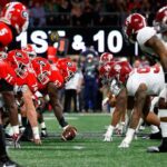 A group of football players are standing on the field.