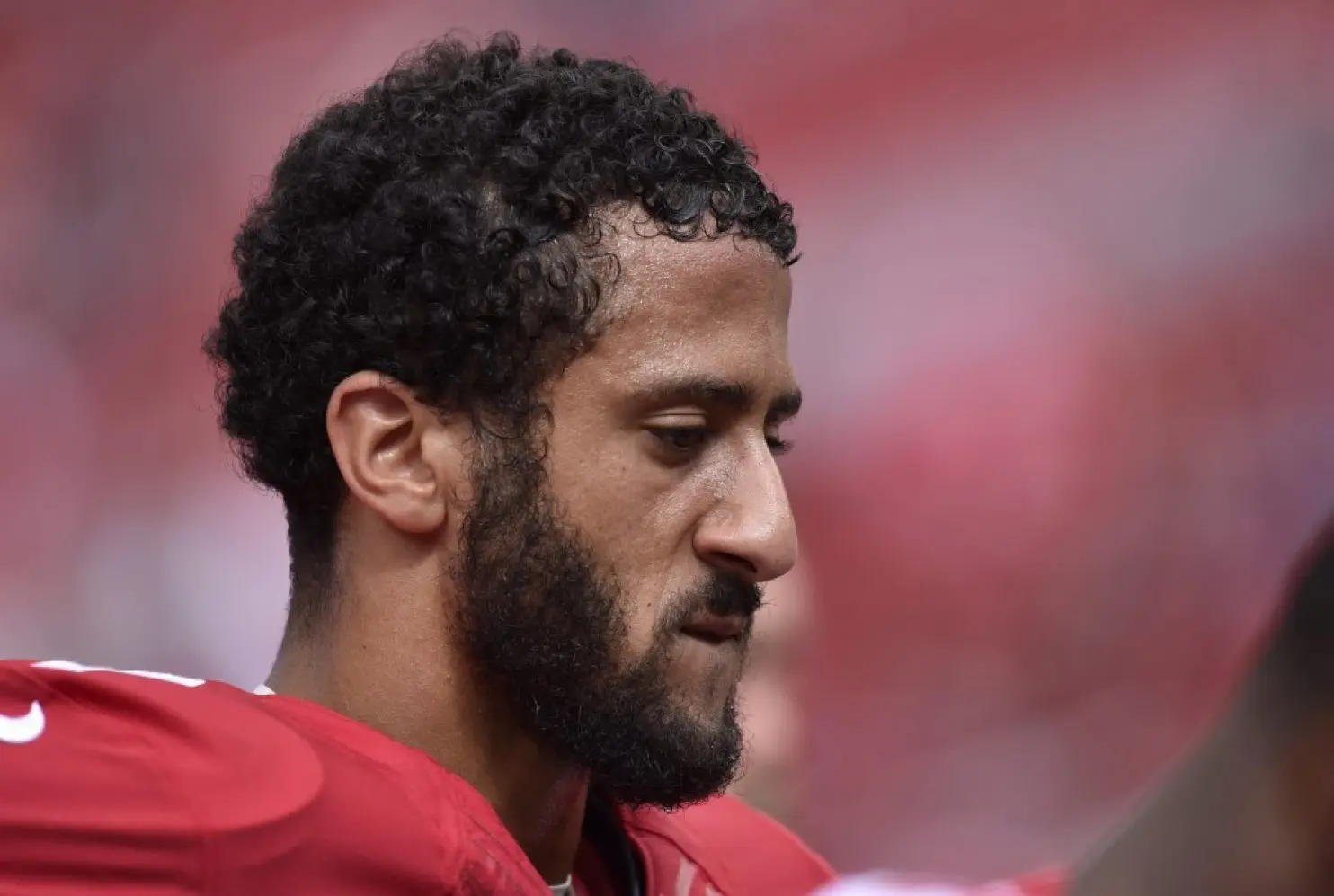 A close up of a football player with a beard