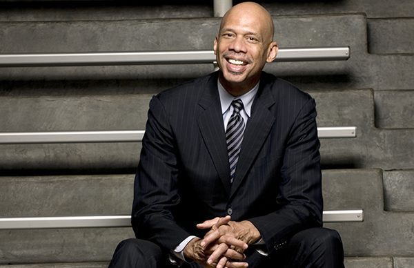 A man in a suit sitting on some steps