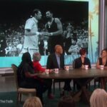 A group of people sitting around a table.