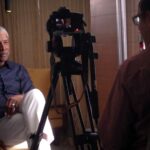 A man sitting in front of a camera.