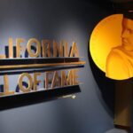 A wall with the california hall of fame logo and a picture.
