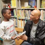 A man and boy in library with books