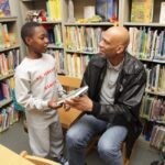 A man and boy in library with books