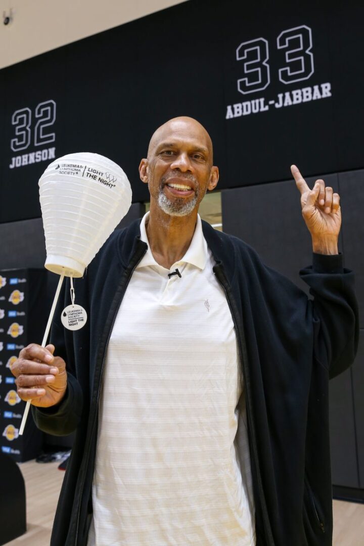 A man holding a white balloon in his hand.