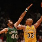 Two men playing basketball on a court