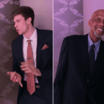 Two men in suits and ties standing next to each other.