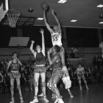 A group of men playing basketball on a court.